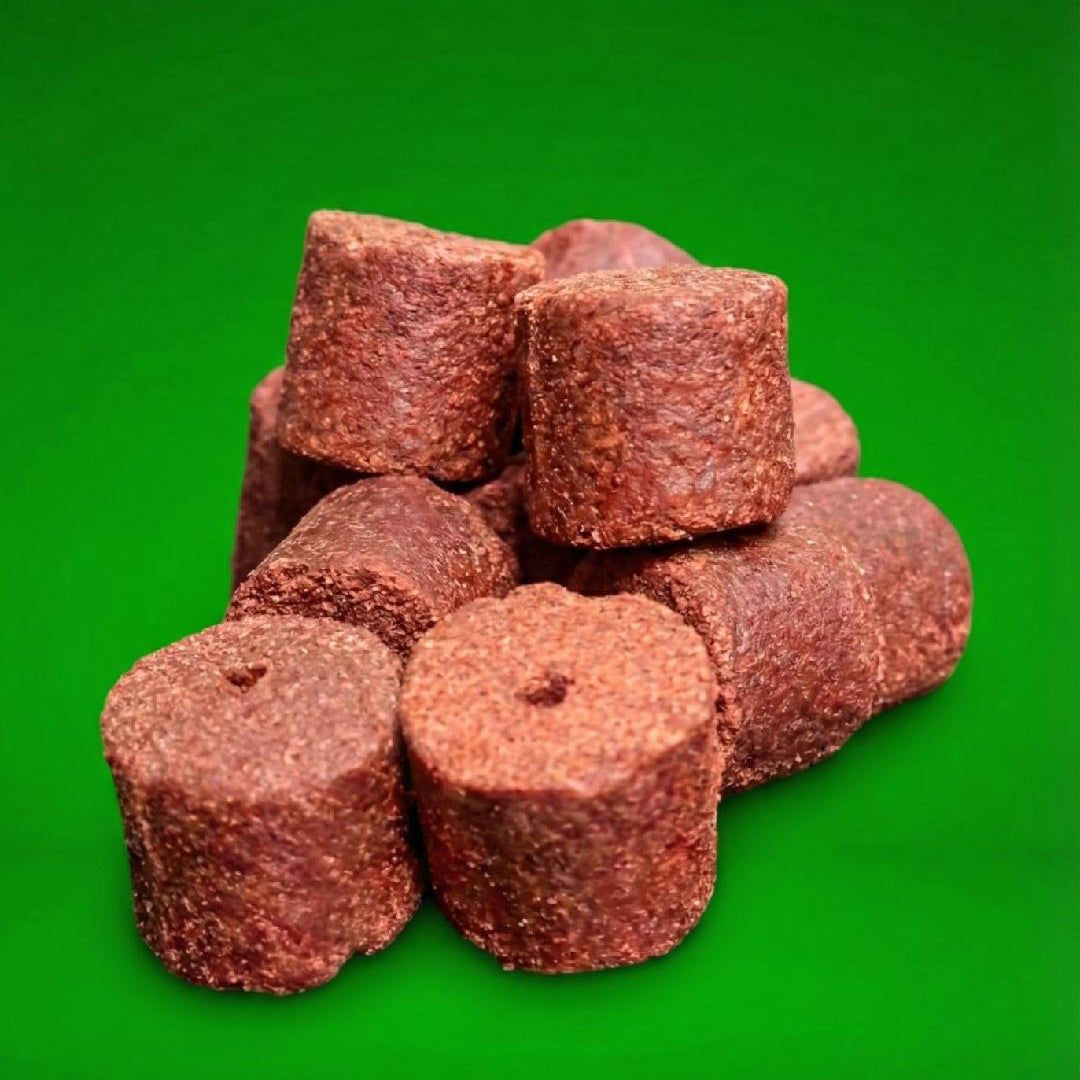  20mm Red Drilled Halibut Pellet on a green background