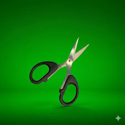 Pair of scissors with black handles on a green background