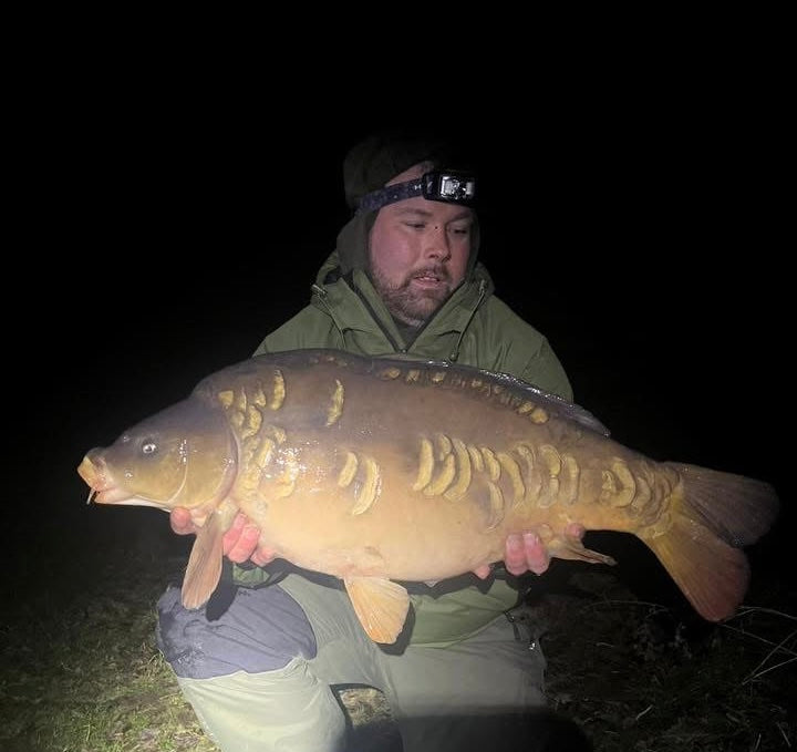 Carp angler fishing at night