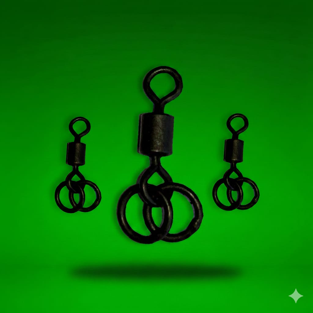Three black fishing swivels on a green background