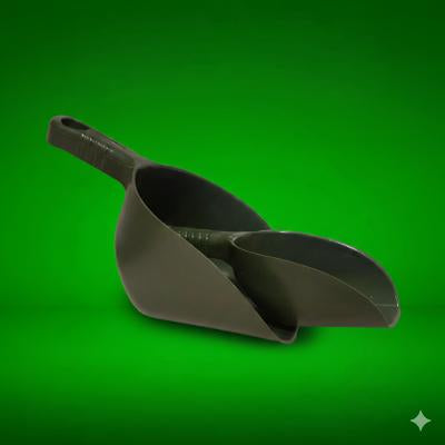 Dark green plastic scoop on a green background