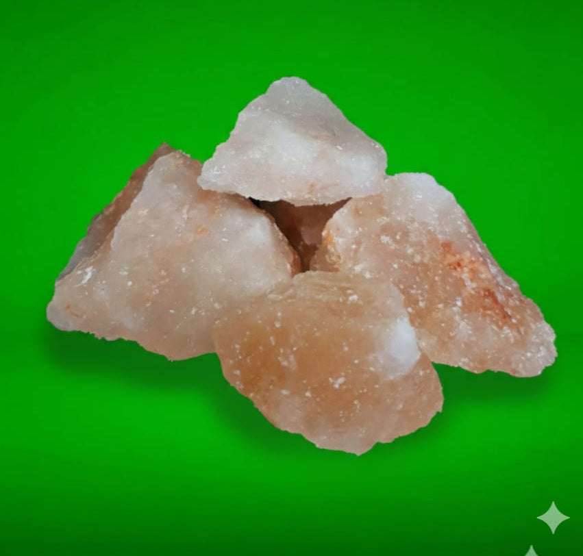 Stack of raw himalayan rock salt on a green background