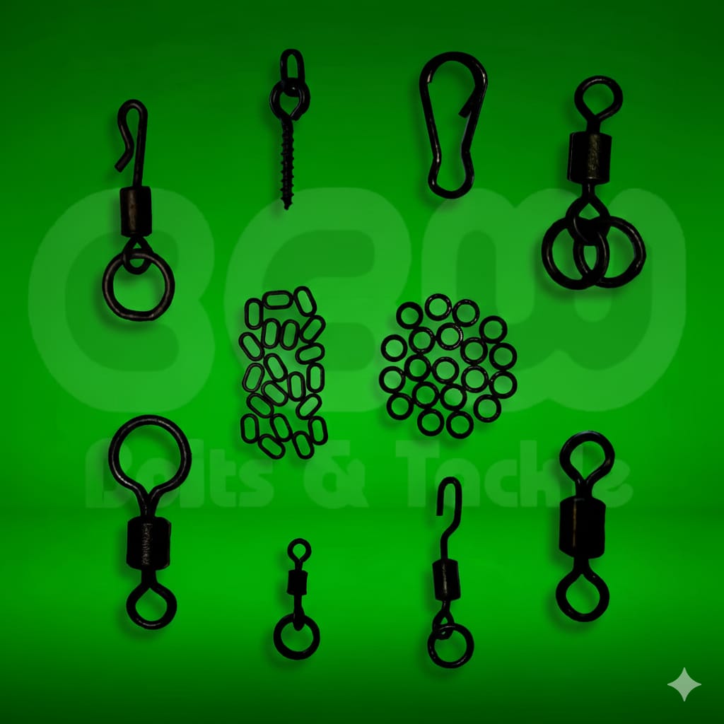 Set of black fishing swivels and clips on a green background